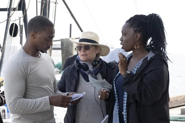 Left to right: Anthony Mackie (Falcon/Sam Wilson), Kari Skogland (director) and Adepero Oduya (Sarah Wilson) on set of 'The Falcon and the Winter Soldier'. Photo by Chuck Zlotnick.