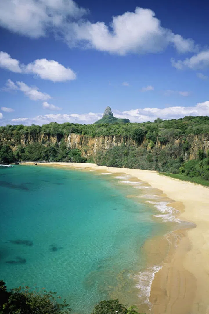 Located 200 miles off Brazil's coast on Fernando de Noronha island, Baia do Sancho is only accessible via boat or by hiking down a narrow staircase from surrounding cliffs making it secluded and virtually untouched.