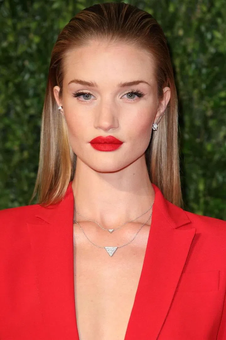All you need is a little water and some hair gel to whip up this slicked-back style. Wet down the top of your hair, brush it back, and then work a styling gel through it until it's fully coated (hair oil can work too, but it's a little messier). Red lipstick and a red suit are optional, but they sure are thematic. 