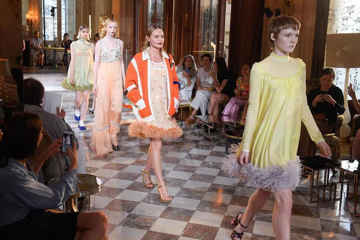 The actress stuns in a preppy orange cardigan on Miu Miu's runway.

Photo: Getty