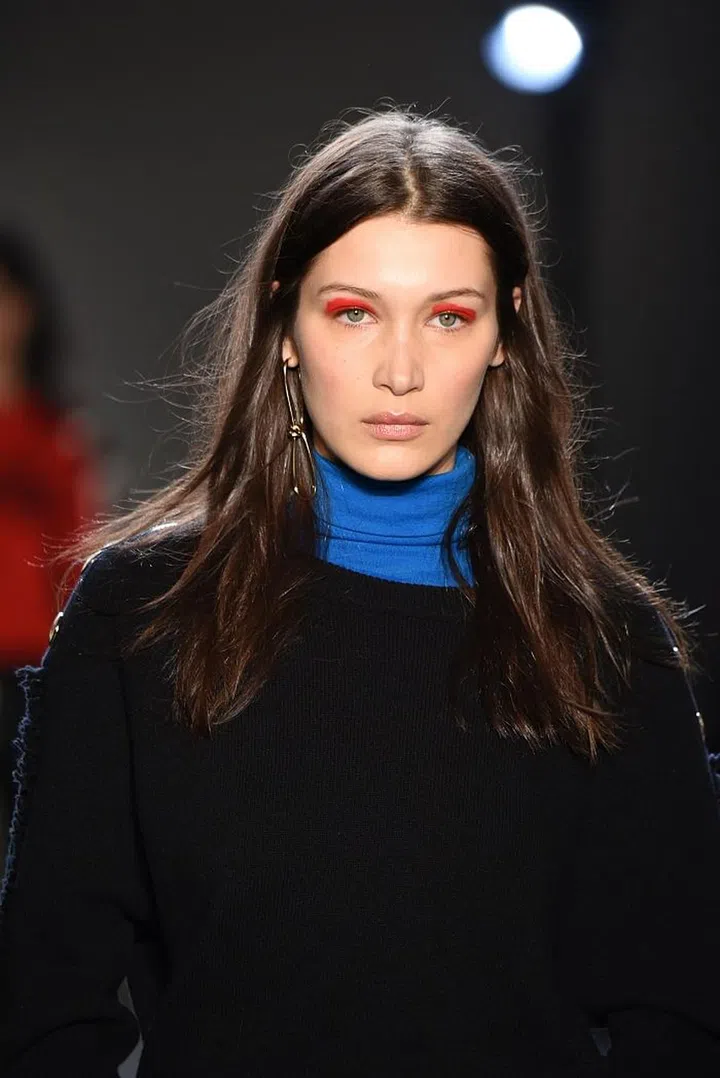 Red, white and yellow eyeshadow is graphically placed on the models' crease. The rest of the face is left toned-down and blank so that the shadows will pop. Photo: Getty 