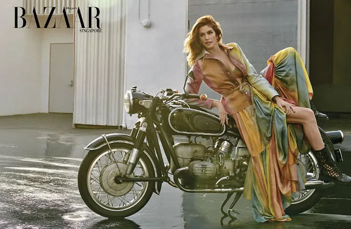 Cotton jacket; knit bra; silk dress (worn as skirt); metal earrings; rope belt; leather boots, Dior.