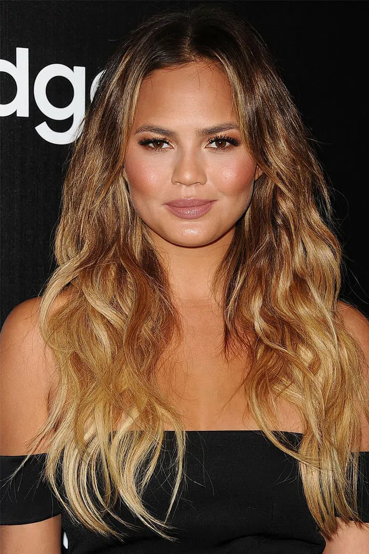 Beachy waves and ombre strands make Teigen's long hair look a must.