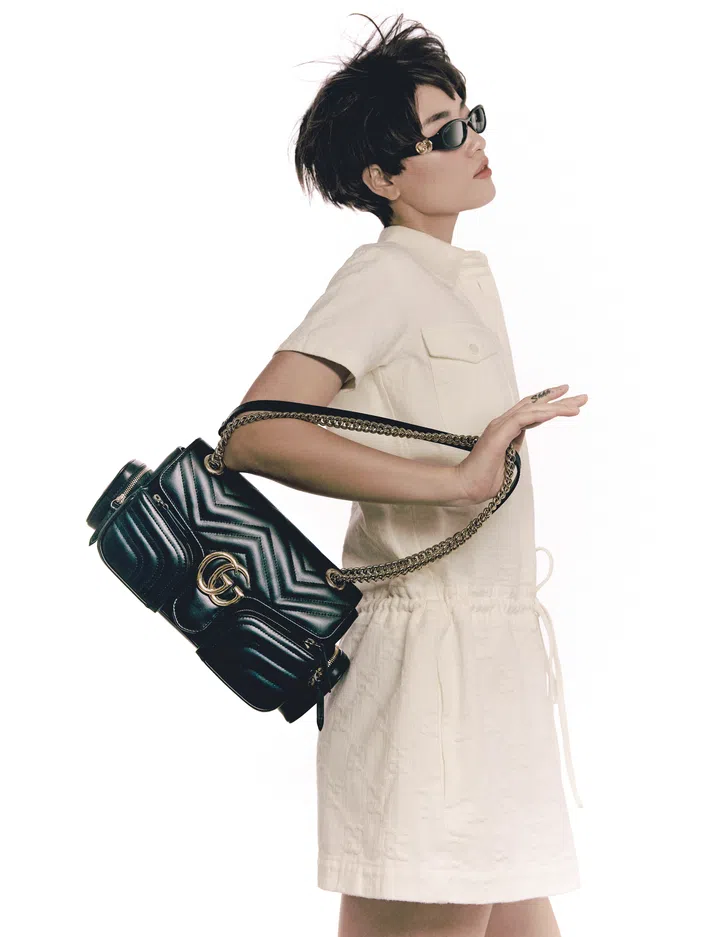 Dress; GG Marmont shoulder bag with multipockets; sunglasses, Gucci. 