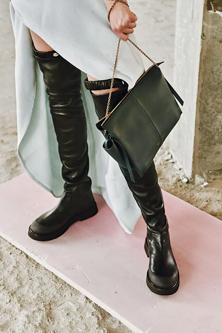Cotton and Viscose Light Double Crepe Long dress; Dark Green Supple Natural Calfskin Tri-Fold clutch on chain; Stretched Nappa Thigh High Country boots, Céline 