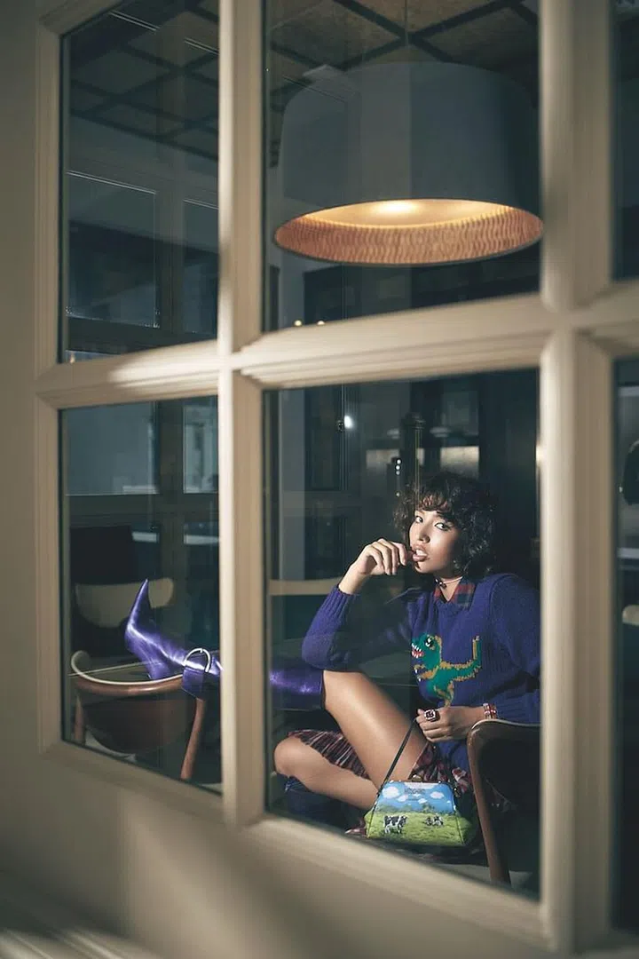 Bag, by Moschino. Sweater; shirt; skirt, all by Coach. Necklace; bracelets; ring, all by Swarovski. Boots, by Balenciaga (Photo: Veronica Tay)