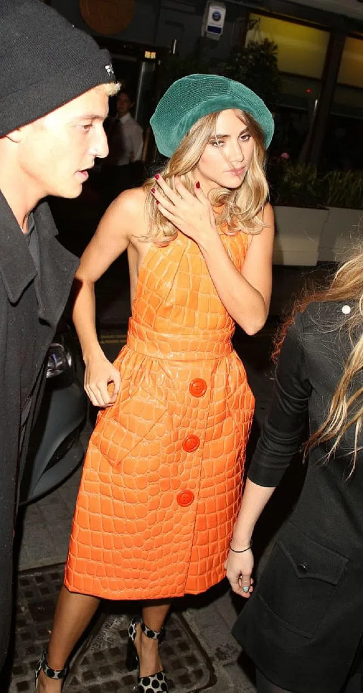 The newsboy cap doesn't always have to be worn straightforward, Suki Waterhouse tipped hers to one side, giving it a little French flair with her cocktail dress. 