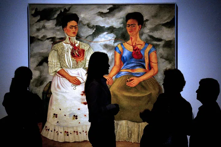 Frida Kahlo's fierce self-portraits featuring her iconic bold unibrow and mustache were once described by André Breton, the founder of Surrealism, as "ribbon[s] around a bomb." Indeed, Kahlo's paintings are simultaneously seductive and confrontational. In The Two Fridas (Las dos Fridas) from 1939, completed shortly after Kahlo's divorce from Mexican muralist Diego Rivera, Kahlo depicts her two personalities—one in traditional Tehuana costume with a broken heart, and the other in modern dress, independent, with a full heart. Kahlo's constant remaking and layering of her own identity was an important predecessor to identity politics, and continues to inspire artists today.
Pictured: The Two Fridas (Las dos Fridas) on display in 2007