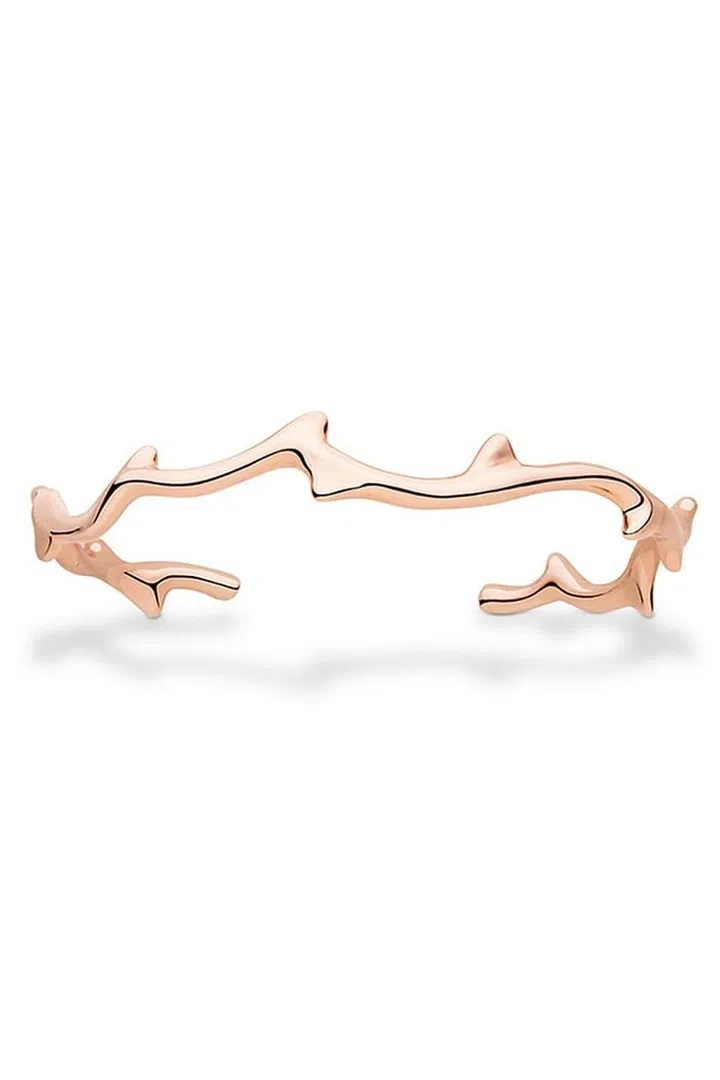 This rose gold Dior bracelet is sleek and minimalist while also including a unique rose-thorn design. 
