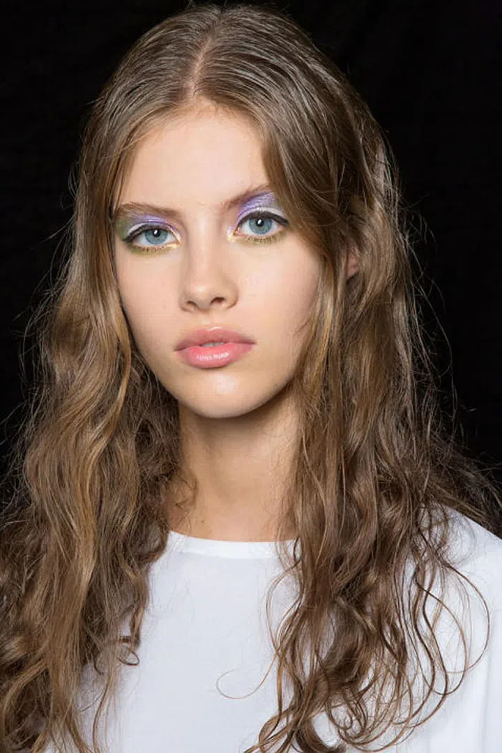 Makeup artist Aaron de May created a rainbow eye on the models backstage at Jill Stuart.