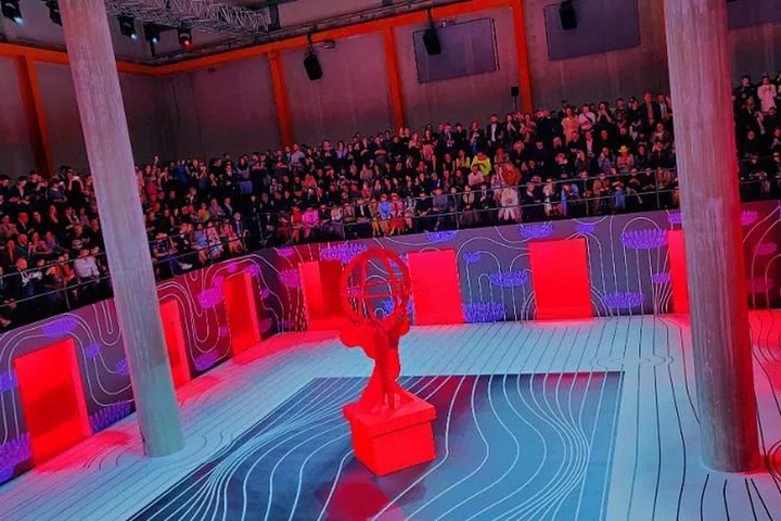 Prada transforms show space into a public arena with a series of sliding and interlocking planes.