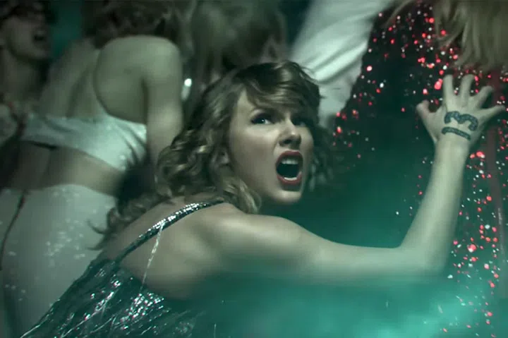 2009 Taylor is back with her curly chignon, her matte red lips, and her iconic "13" painted on her hand, but this time, nobody's letting her finish.