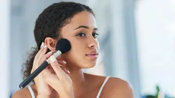 Woman powdering face