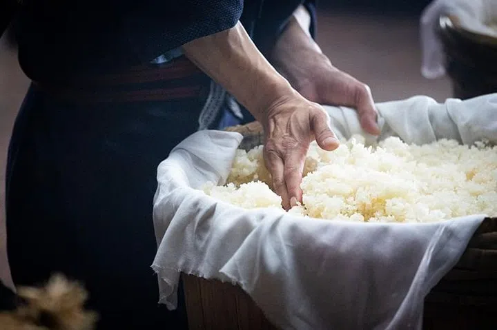 The anti-ageing efficacy of Pitera Essence, evidenced by the smooth, young hands of a veteran sake brewer