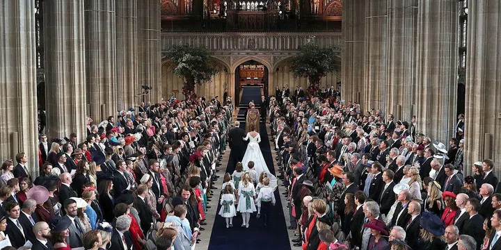 Prince Andrew walks his youngest daughter down the lengthy aisle.
