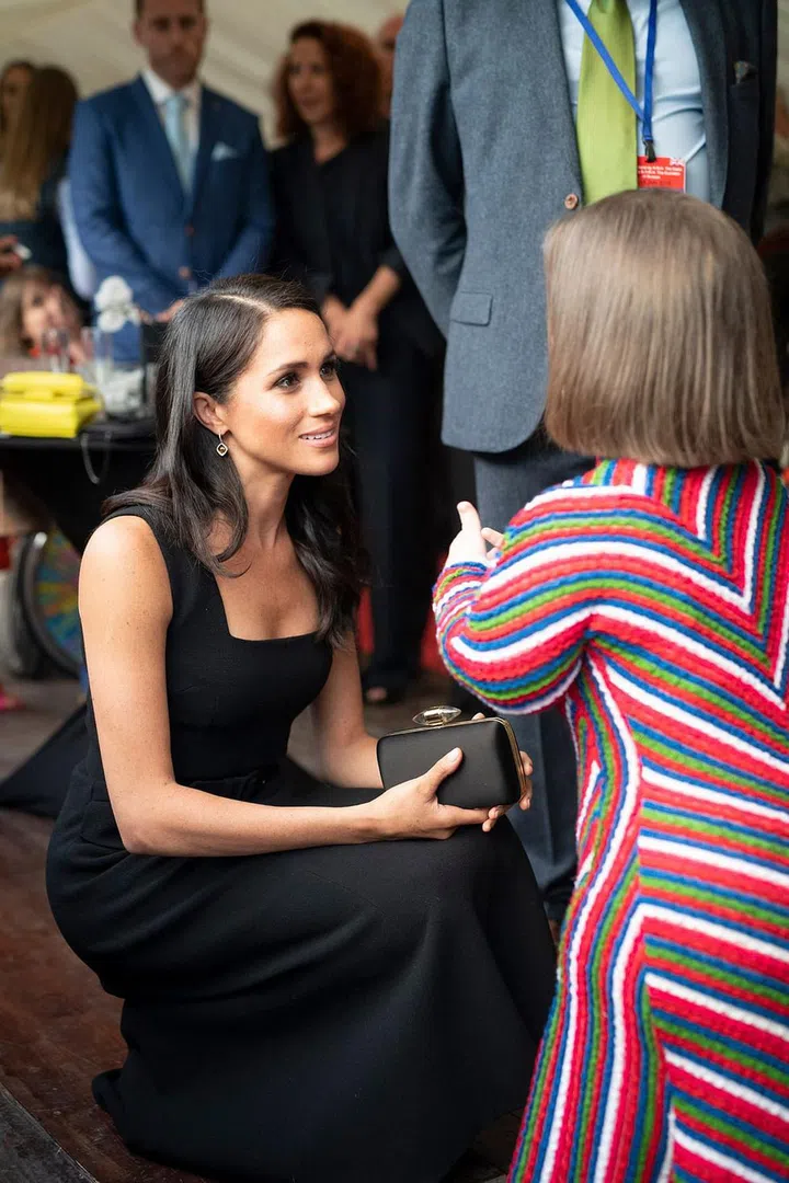Markle speaks to Irish writer Sinead Burke at the garden party.

Photo: Getty