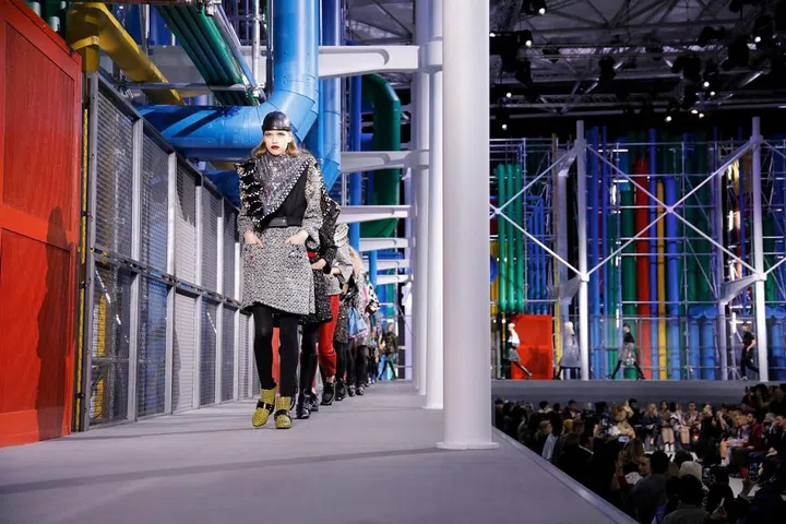 This season might be all about ’70s bourgeois chic but Nicolas Ghesquière has always been an avowed ’80s fanboy. The fashions of the era were polarising—loved and loathed in equal measure—so it seemed fitting that Ghesquière would erect the equally polarising façade of the Centre Pompidou in the Louvre to frame his latest collection. The clothes were an homage to the decade with faces framed by sculptural ruffles, oversized lapels or crystal-encrusted neckerchief collars. Skirts were short with flippy hems, and shoulders and sleeves were of statement-making proportions—all grounded by fl at boots and shoes for a decidedly modern attitude.