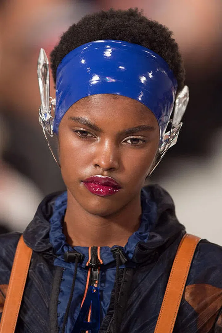 At Maison Margiela, makeup artist Pat McGrath treated a few models to a glossy plum lip accented by a line of metallic pigment above the cupid's bow (using Pat McGrath Labs Metalmorphosis 005). 
