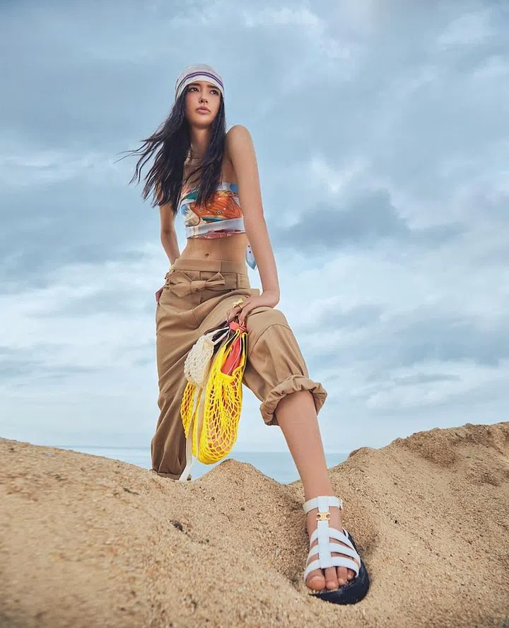 Scarves (worn as a top, and around the head and a bag handle); bangle, Hermès. Trousers, Max Mara. Charm necklace, Dior. Ring, Kate Spade New York. Bags, Longchamp. Sandal, CELINE. (Photo:  Phyllicia Wang)