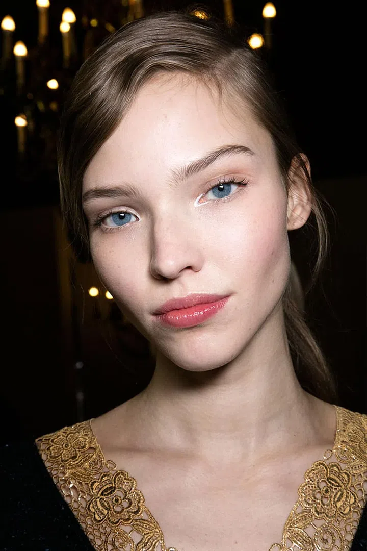 Take a break from the three-step method of shading, blushing and highlighting you learned in Contouring 101: The prettiest skin (see: Stella McCartney, left) was neither highly-reflective nor blur tool mattified; there was just a little shine where there's normally shine and a pink flush where there should be flush. Arm yourself with blush, a tinted lip balm and mascara and your look is done in three minutes flat.
Photo: Imaxtree