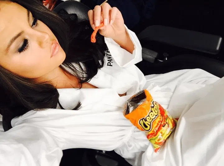 White robe, fully-done hair and makeup, nice chair to perch in, Cheeto delicately held in manicured fingers. It's all part of the process.
Photo: Instagram