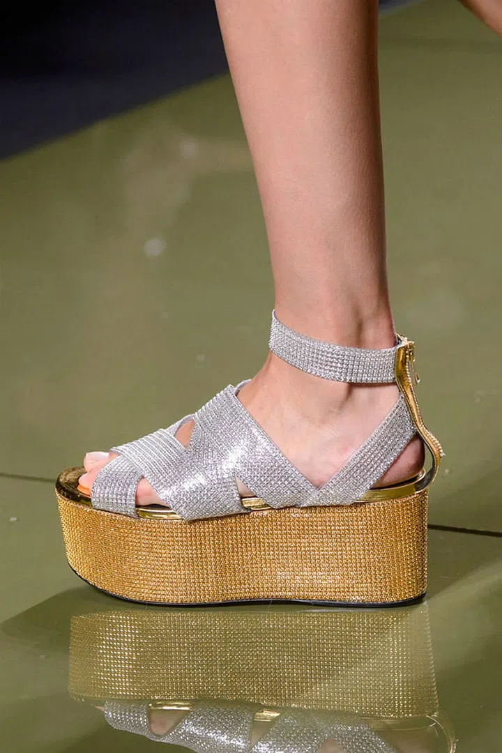 And just like that, flatforms are back. Consider it all the height, none of the pitch, with wooden takes at Balmain, sporty iterations at Dolce, Teva inspiration at Versace and white leather at Gucci. 
Pictured: Balmain
