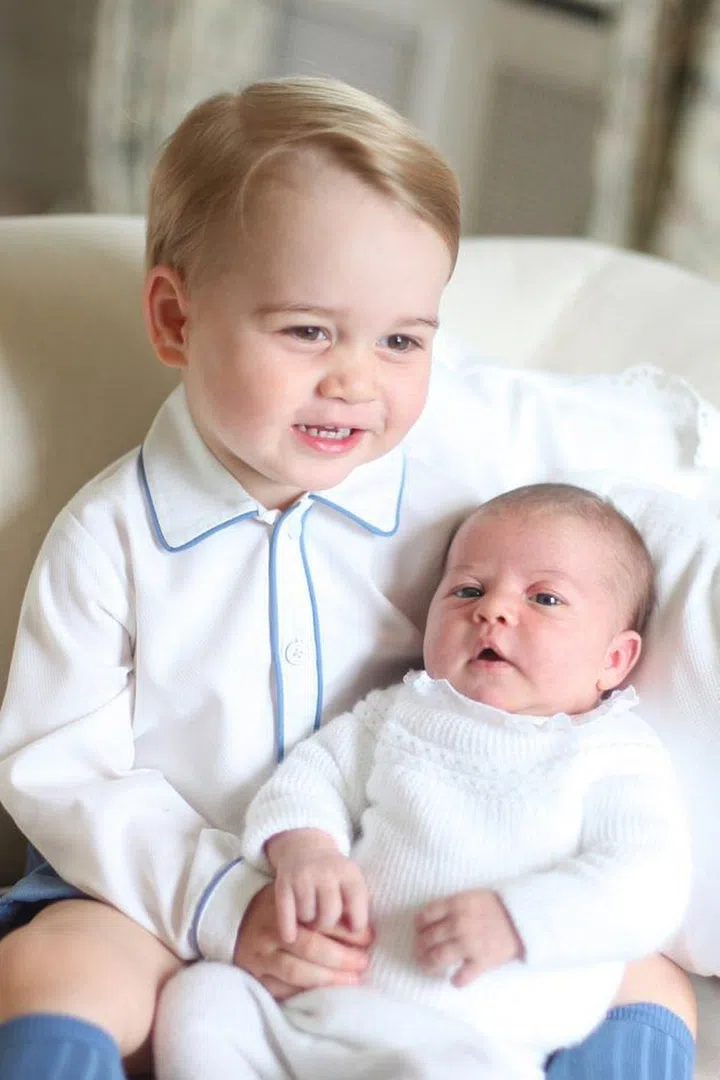 EMBARGOED TO 22:00 BST Saturday June 6. This picture, or pages featuring this picture, must not be tweeted or used on any social media until after 22:00 Saturday.  Copyright: HRH The Duchess of Cambridge 2015. NEWS EDITORIAL USE ONLY. NO COMMERCIAL USE (including any use in merchandising, advertising or any other non-editorial use including, for example, calendars, books and supplements). This photograph is provided to you strictly on condition that you will make no charge for the supply, release or publication of it and that these conditions and restrictions will apply (and that you will pass these on) to any organisation to whom you supply it. All other requests for use should be directed to the Press Office at Kensington Palace in writing.
Undated handout photo released by the Duke and Duchess of Cambridge of Prince George and Princess Charlotte. The photograph was taken by the Duchess in mid-May at Anmer Hall in Norfolk. PRESS ASSOCIATION Photo. Issue date: Saturday June 6, 2015. See PA story ROYAL Baby. Photo credit should read: Duchess of Cambridge.