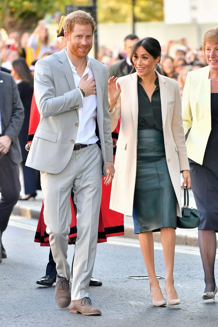 For the occasion, Meghan opted for a dark green Hugo Boss skirt and matching Gabriela Hearst bag, with a green & Other Stories shirt, nude Armani coat and nude heels. Harry opted for a pale grey suit with open-collar shirt.