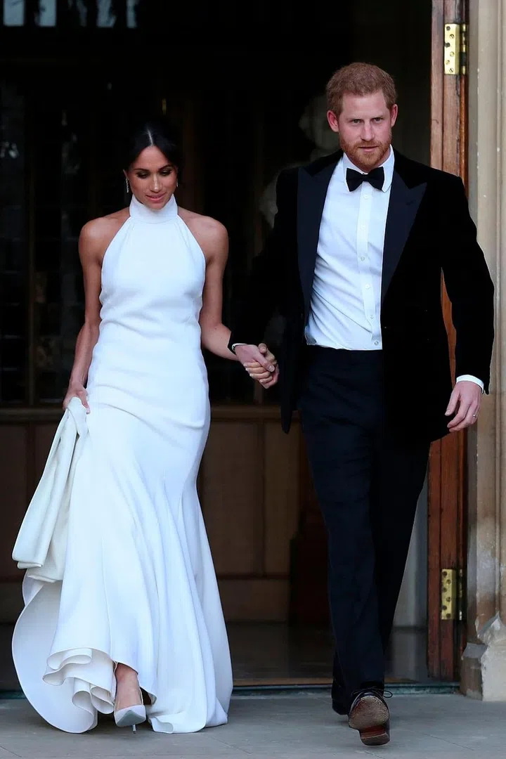The newly married Prince Harry, Duke of Sussex and Meghan Markle, Duchess of Sussex, leave to attend an evening reception at Frogmore House.