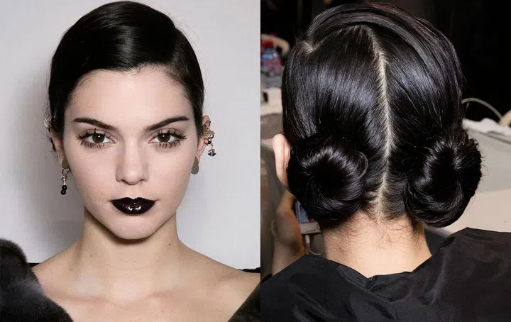 According to Peter Philips, Creative and Image Director of Christian Dior Makeup, the beauty look all started with a so-dark-it's-almost-black purple lipstick called Poison that current designers Lucie Meier and Serge Ruffieux loved. From there, "it was all about contradictions," said Philips. "They went for something boyish with the hair, but at the same time, buns are girly. With the makeup, we went for a really sophisticated, intense, almost dangerous lip, but to make it less gothic and more glamorous, we added a high gloss, high shine. For the eyes, I said, 'let's go for extreme volume in mascara, but not like a beautiful fan of lashes, a bit more punkish.'" His trick for making the lip color both opaque and dimensional is four-pronged: Outline the lips in matching 'Poison' lip liner, fill them in with black eyeliner, apply the lipstick (twice, mattifying with a Kleenex in between), then go over with lip gloss right before the runway, so as not to get a swipe of lacquered black across the clothes. The lashes, which Philips euphemistically described as "packages of lashes" rather than clumpy, were achieved through first brushing on a clear primer, then going over that with two coats of black mascara, the second one applied in swirling fan motions as the first was almost dry. Over in hair, Guido was giving models two low mini twists on either side of the head, a nod to the '20s and '30s—and not to Björk, Princess Leia or prairie girls.