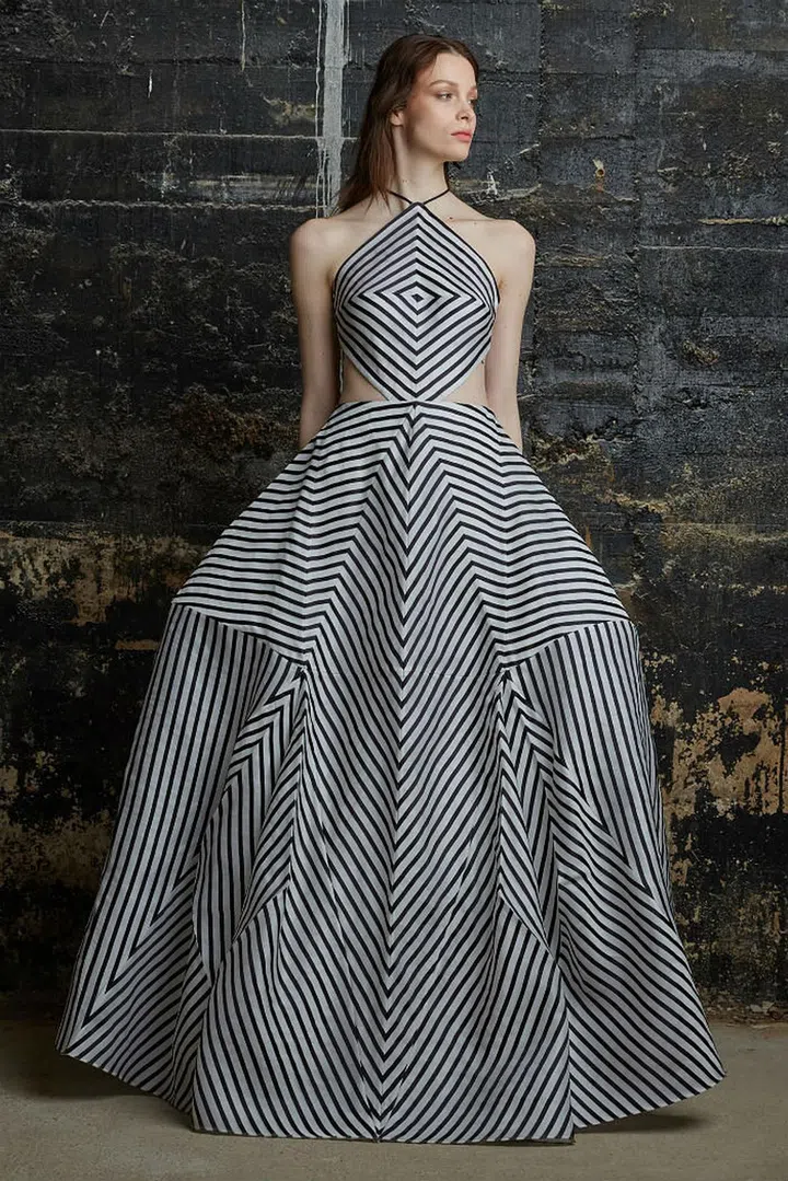 Rosie Assoulin's feminine, voluminous and sculptural evening-wear have been spotted on red carpet favourites such as Rihanna and Beyoncé.

This standout evening gown from her fall/winter 2015 collection, featuring angular lines and geometric shapes, was inspired by the Brion Cemetery by Italian architect Carlo Scarpa. 