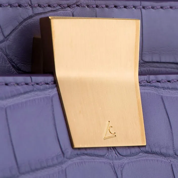 The gold hardware of Leo Camerini bags bearing the brand's LC logo
