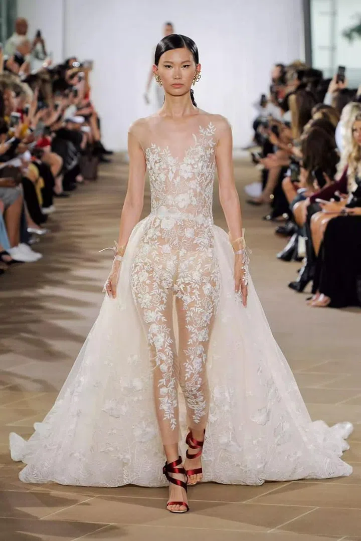 If you’re not all that into dresses or looking for a chic alternative to the usual frock, consider the bridal jumpsuit which had a big moment this season. This one-piece trend is not only practical; it is an effortless alternative and perfect for the after party. From lacey versions such as in Ines di Santo, to modern iterations from Savannah Miller, there is sure to be a jumpsuit to suit your taste buds.