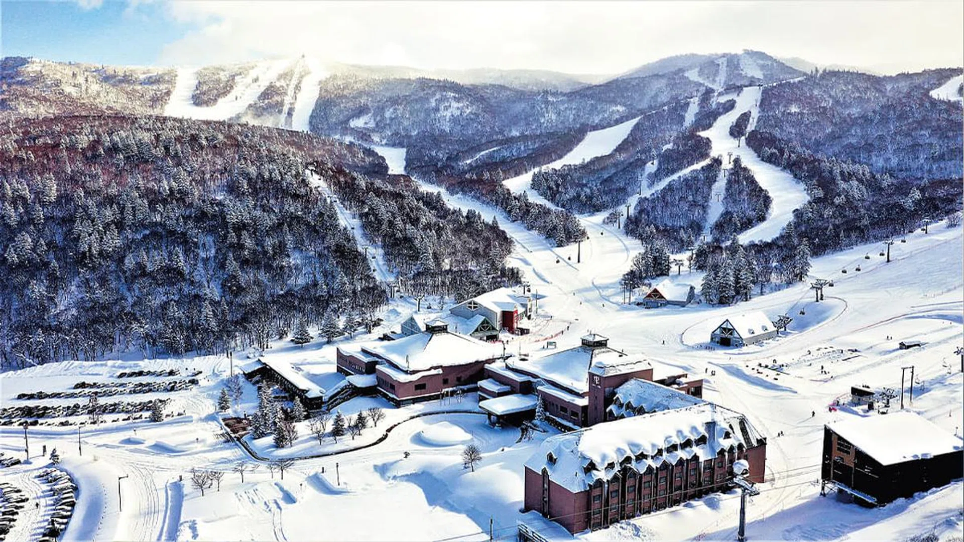 Aerial view of Club Med Kiroro Peak blanketed in snow.