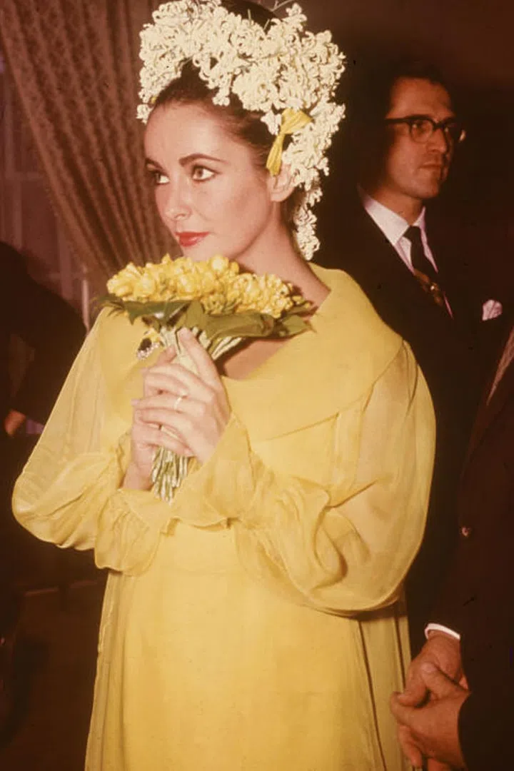 For her wedding to fifth husband Richard Burton, Taylor opted for a canary yellow chiffon dress topped off with dozens of white flowers in her hair. While her penchant for getting married certainly made the news more than her gowns, this dress definitely falls into the "unconventional" category.