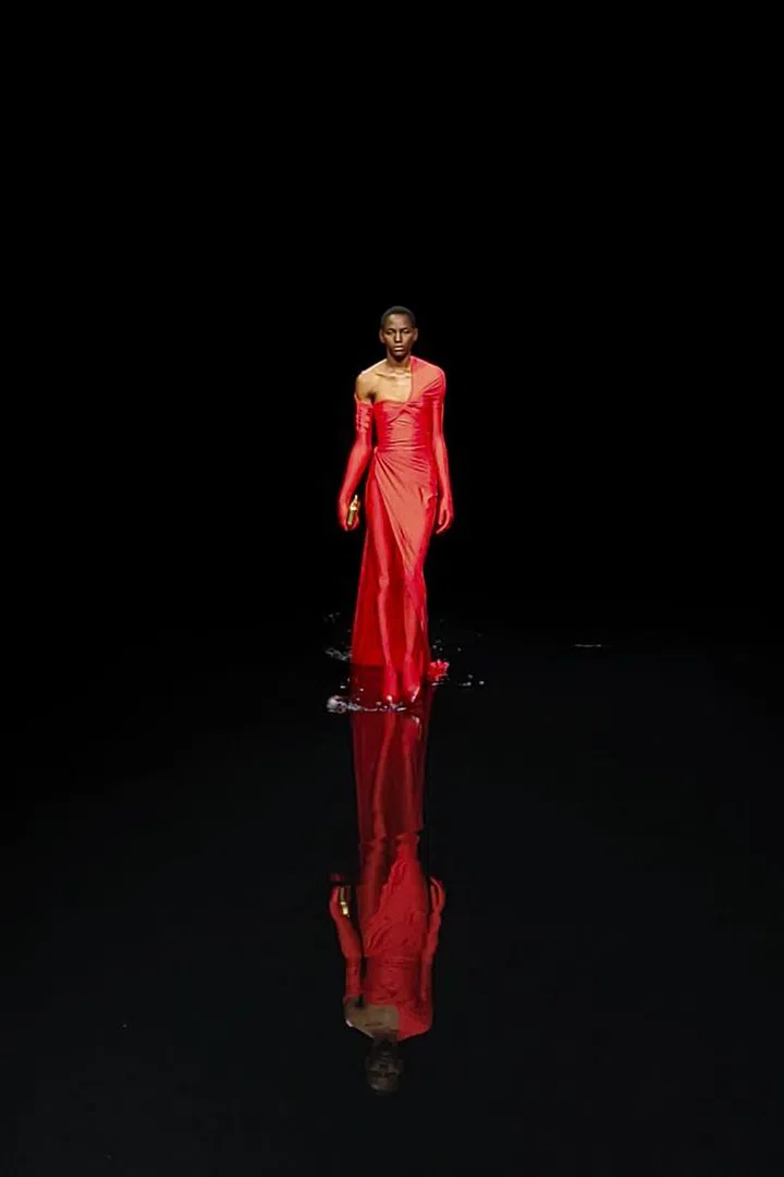 This striking red look at Balenciaga reflected in the water on the runway.