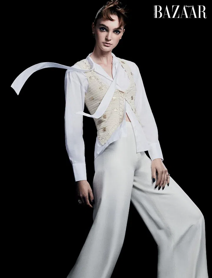 Vest, Sandro. Top, Max & Co. Trousers, Ralph Lauren. Earring; rings, Dior.