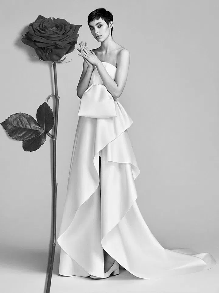 Slim sheaths with draping details (especially ones that showcase your shoes) are easy, chic ways to maintain a laid- back feel with a dose of formality. Viktor & Rolf "Couture Tie Gown", viktor-rolf.com. Photo: Viktor & Rolf