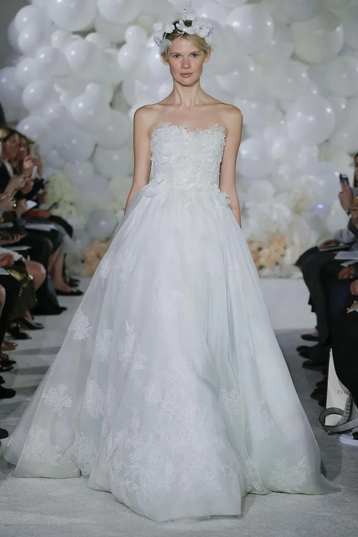 Classic shapes-like sweetheart necklines and dramatic ball skirts-work best for outdoor locations when they're accented with textural elements. Mira Zwillinger, mirazwillinger.com. 