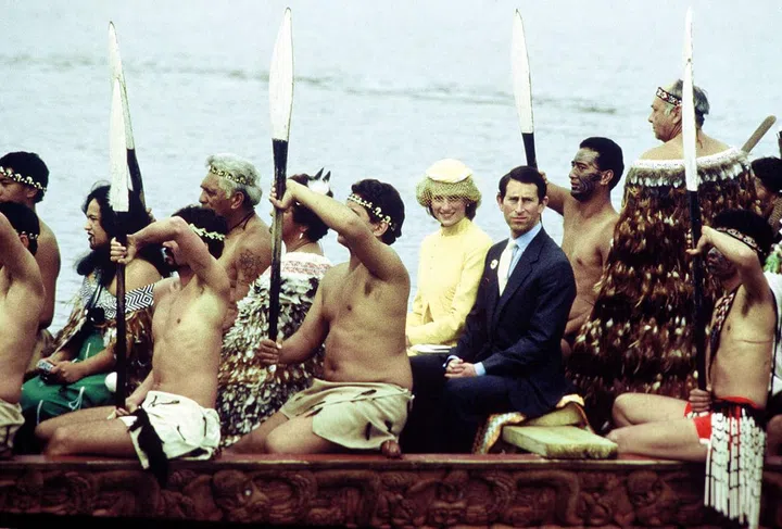 In a John Boyd yellow suit and hat while riding in a Maori canoe at the Bay Of Islands, New Zealand with Prince Charles. Photo: Getty