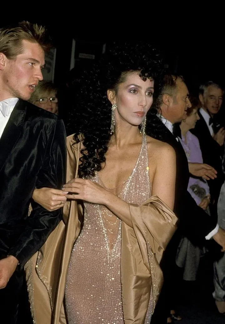 In her first year as an official Oscar nominee, Cher showed up for the occasion in a sparkling naked dress designed by none other than Bob Mackie. She accessorized the look with dangling diamond earrings and boyfriend Val Kilmer. 