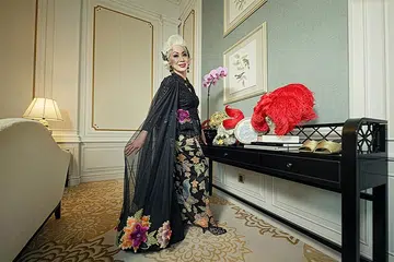 Harper’s Bazaar Singapore 25th Anniversary Where Fashion Live | Genevieve Peggy Jeffs in a custom feathered cape, gold headdress and pearl jewellery