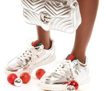 Gucci Ancora red Blondie small shoulder bag and Horsebit ballet flats shot together with metallic silver GG Marmont bag and Re-Web sneakers.