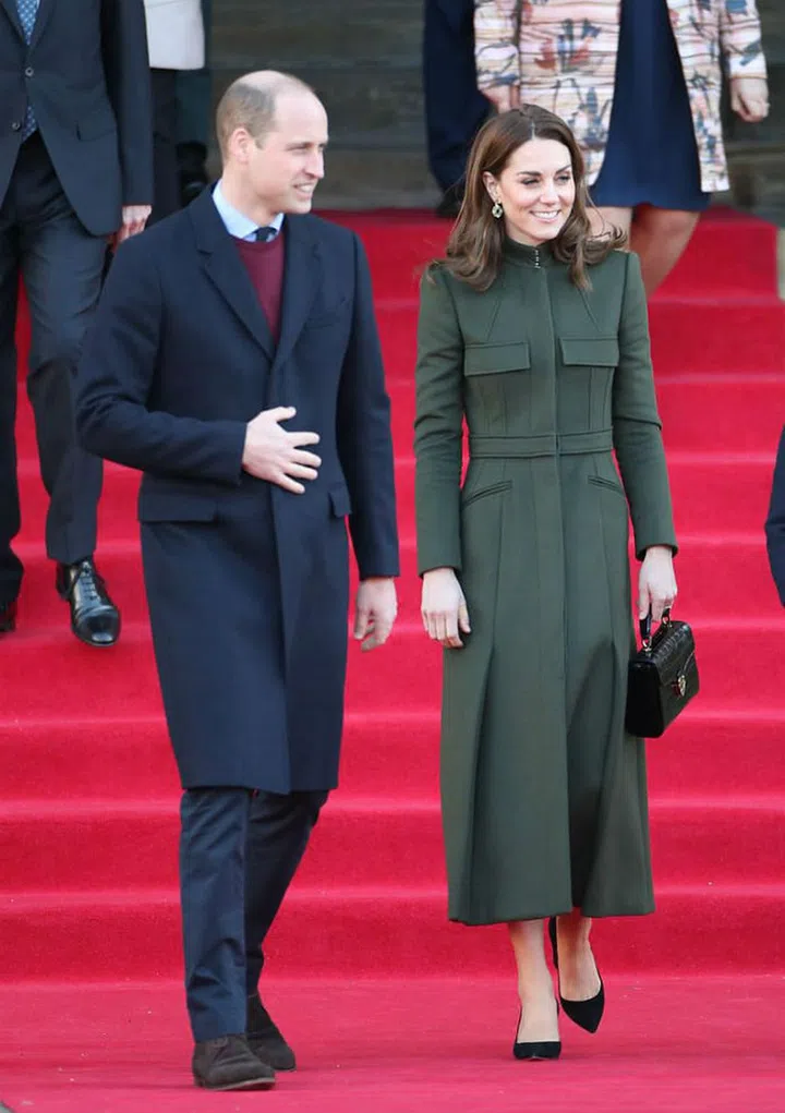Kate Middleton wore a mossy green Alexander McQueen coat over a Zara dress while visiting the city of Bradford alongside Prince William—the Cambridges' first royal outing of 2020. The duchess accessorised with black high heels, a black bag by Aspinal London and and gold drop earrings by Pakistani jewellery label Zeen.