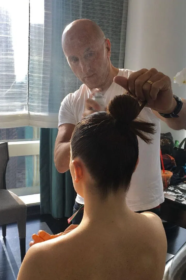 "I started by blow drying the hair using Leonor Greyl Mousse au Lotus Volumatrice to create texture and shine. then I took two sections, the top and sides and by pulling the top section to the crown and combing the two sides and back up to meet the top, arranged a tight ponytail," says Vetica. Photo: Getty 
