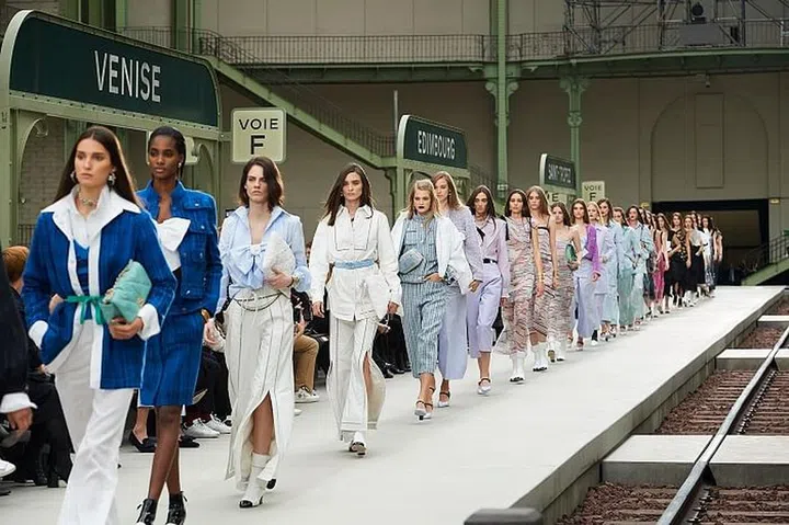 When the fashion cognoscenti arrived at the Grand Palais, some noted the relatively simple train station set-up. Shocking, really, from a house that had in the past conjured up faraway beaches, glorious waterfalls and even a spaceship. In retrospect, this was a good thing perhaps, since it marked Virginie Viard’s first solo outing as artistic director. All attention was placed on the clothes, and not on pomp and pageantry. Signages on set pointed to locales of cruise shows past, but this time, the return to Paris was done with purpose and intent: Bring it all back to this century-old French house’s DNA. With over three decades spent under Lagerfeld’s tutelage, it’s Viard’s time in the spotlight. She debuted androgynous work-appropriate sets: Wide-legged trousers worn with white poplin blouses under tailored jackets in neutrals. They were reminiscent of Coco Chanel’s approach, evoking a sense of casual cool. The brand’s signature tweed jackets followed in punchy colours, paired with printed jersey leggings. Then came oversize bows fashioned into bustiers and delicately tiered chiffon dresses. The final gown spoke volumes; the minimalist column of black linen juxtaposed with a stiff white shirt-collar was an unmistakable nod to Lagerfeld’s uniform of choice. The collection paid homage to both Chanel and Lagerfeld, 
 yet displayed Viard’s own sensibilities—ones that were softer and more pared back, clearly showing the effect of a modern, French woman’s touch. 