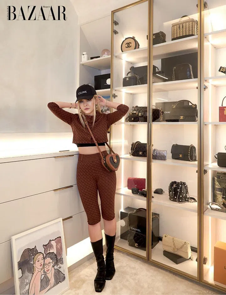 Chng, wearing her own Miaou top and tights, CELINE cap and bag, jewellery from Cartier, Chanel and Lucere Jewellery, and Rick Owens shoes, in one of the couple’s walk-in closets.