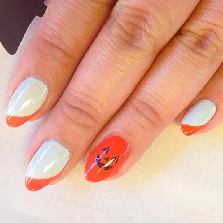 The cutest little pumpkin by Sigourney B. Nuñez (@nailartbysig). She used a discontinued JINSoon shade, Pumpkin, but Enflameé would work, too.