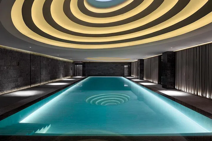 Sculptural skylights, inspired by Balinese rice fields, light up the 25-meter underground pool at the Temple House in Chengdu, China. "The pool reflects natural light from our dramatic ceiling skylights mirroring the landscape above," says Kelly Coates Xu, the hotel's spa director.