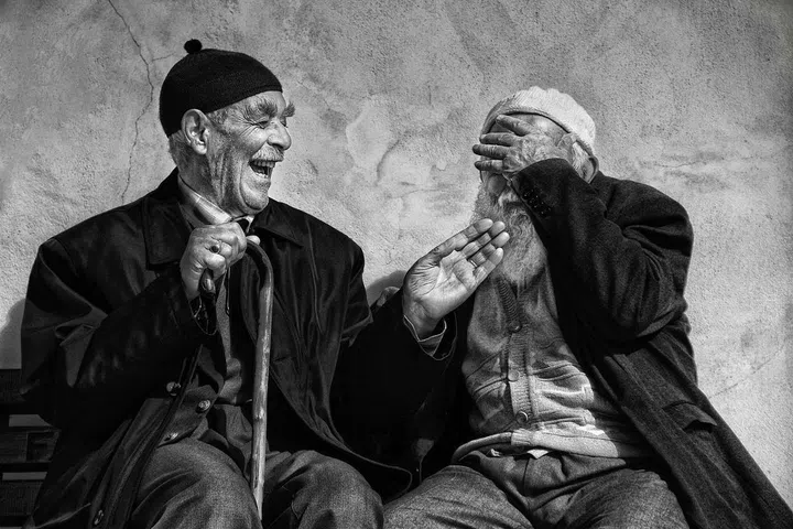 "Two elderly men who enjoy a jovial conversation in a mosque courtyard. Life is intimately connected with dialogue."–Mine Ertugrul